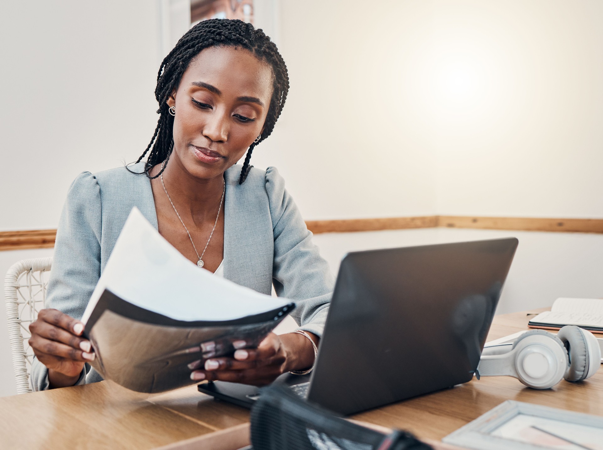 Black woman with compliance documents, consultant working on strategy and performance reporting. Support in tracking information to meet deadlines