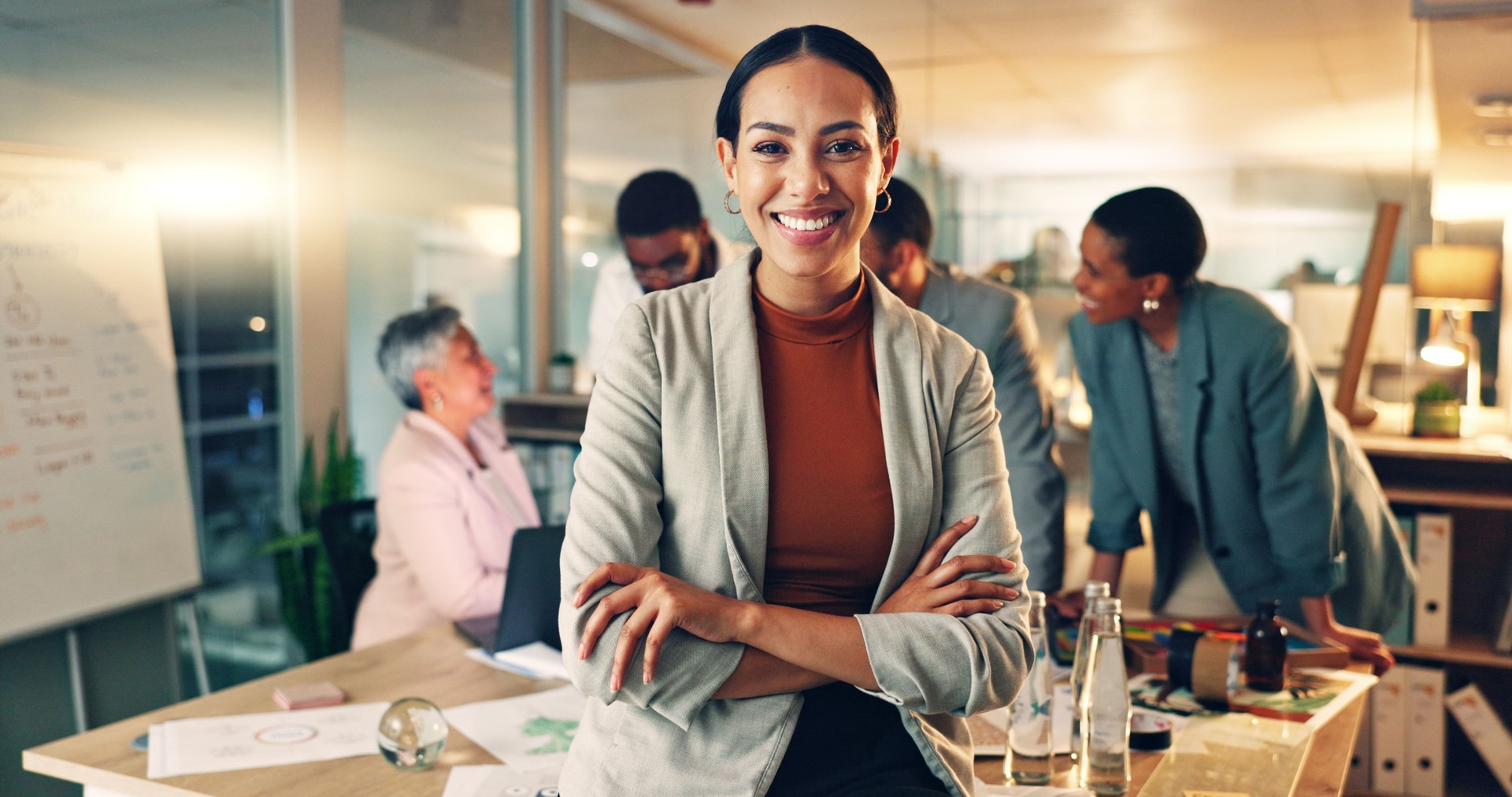 Face, business and woman with arms crossed, team planning for planning and operational support. Portrait, person or employee with cooperation, staff or professional with brainstorming in a workplace